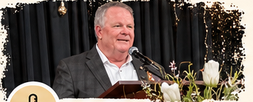Stan speaking at a lectern